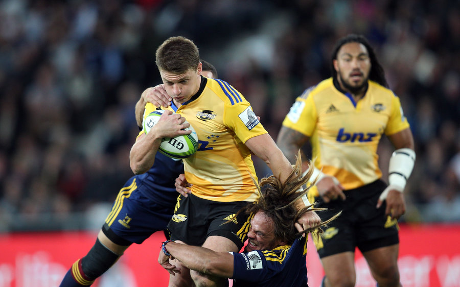 Beauden Barrett of the Hurricanes attempts to bust the Highlanders defence