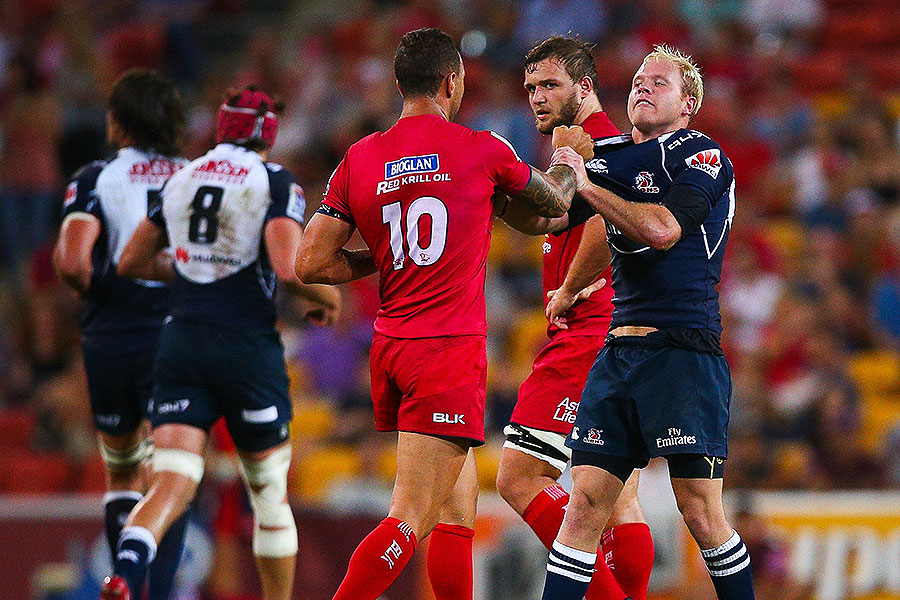 The Reds' Quade Cooper wrestles with the Lions' Ross Cronje