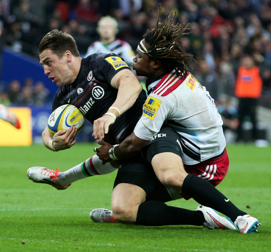 Saracens' Chris Wyles scores his second try despite the efforts of Harlequins' Marland Yarde
