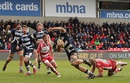 Josh Beaumont of Sale Sharks slips the tackle of Gloucester's Billy Twelvetrees