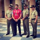 Queensland Reds captain James Slipper unveils the Reds' ANZAC day commemorative jersey alongside members of Brisbane's 7th Brigade 