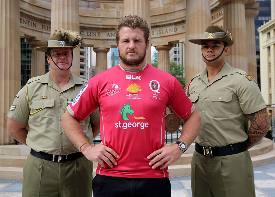 Reds captain James Slipper with Corporal Adam Brown and Private Leone Fifita unveiling the Reds' commemorative ANZAC jersey