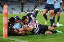 Rob Horne of the Waratahs beats the defence to score a try