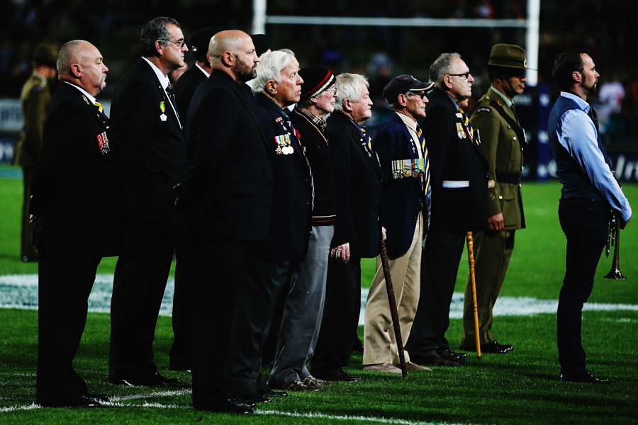 Former New Zealand servicemen observe a moment of silence to mark Anzac Day