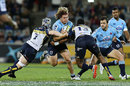 The Waratahs' Michael Hooper charges at the defence