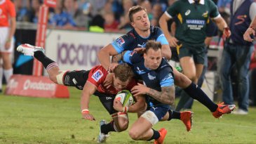 Andries Coetzee of the Lions tackled by Handre Pollard and Francois Hougaard of the Bulls, Bulls v Lions, Super Rugby, Loftus Versfeld, Pretoria, May 2, 2015
