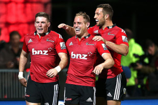 The Crusaders' Colin Slade (L), Andy Ellis (C) and Tom Taylor celebrate a try, Crusaders v Reds, Christchurch, May 8, 2015