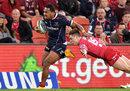 Sefanaia Naivalu of the Rebels breaks away from Reds' James O'Connor