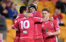 Reds' Jake McIntyre is congratulated by team-mates after scoring a try
