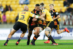 Hika Elliot of the Chiefs is tackled by Ben Franks (L) and Jeremy Thrush of the Hurricanes, Hurricanes v Chiefs, Super Rugby, Westpac Stadium, Wellington, May 16, 2015