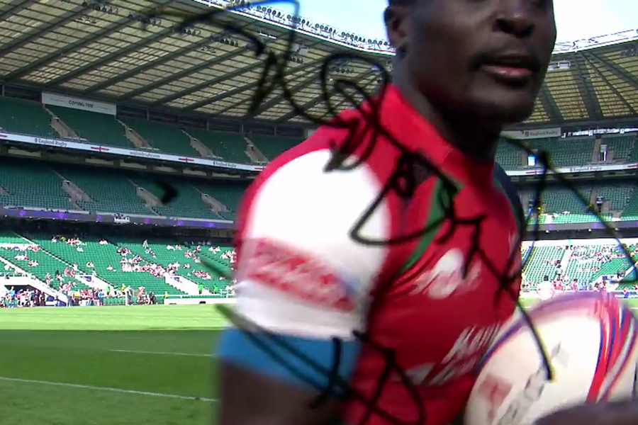 Kenya's Collins Injera signs a camera after scoring his 200th try