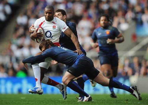 England wing Ugo Monye is tackled by the France defence