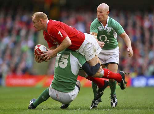 Wales' Martyn Williams looks to offload as he is tackled