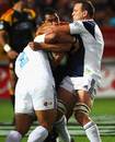 Mils Muliaina  of the Chiefs is sandwiched by Justin Collins and Keven Mealamu of the Blues