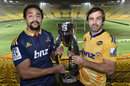 Captain of the Hurricanes Conrad Smith (R) holds the Super 15 trophy with captain of the Highlanders Nasi Manu