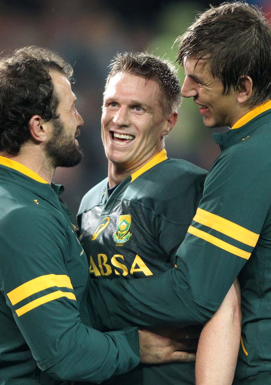 Jean de Villiers of South Africa is congratulated by team-mates during the Springboks win over World XV