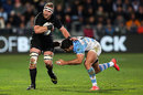 New Zealand's Kieran Read slides on the outside of a Pumas' defender