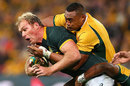 South Africa's Schalk Burger is tackled by Australia's Sekope Kepu