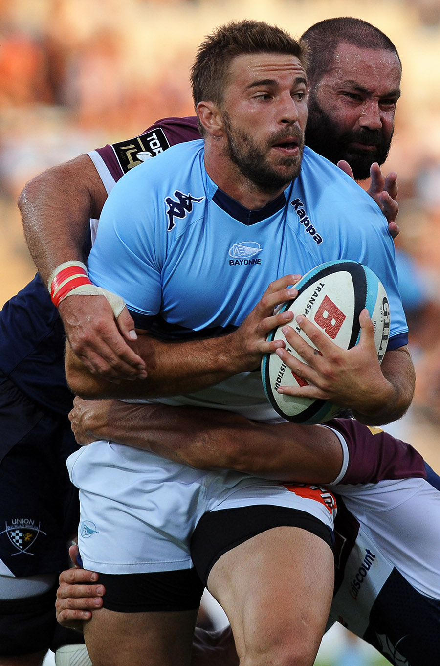 Bayonne's fullback Benjamin Thierry (L) is tackled by Bordeaux's number 8 Matthew Clarkin during a friednly