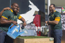 South Africans pour water onto a patch of grass grown for the South African Springbok rugby team ahead of the Rugby World Cup 2015