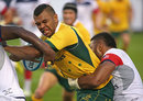 Kurtley Beale of the Australia Wallabies tries to fight his way between two United States Eagles players