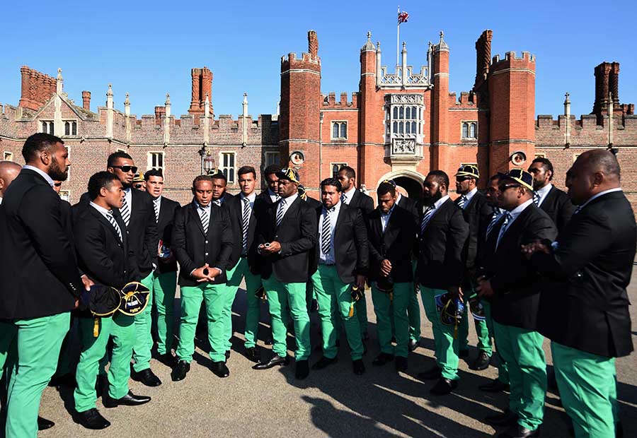 Members of the the Fiji 2015 World Cup Rugby Union squad sing outside Hampton Court Palace following their official welcoming Ceremony
