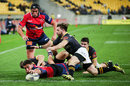 Kieron Fonotia of Tasman scores a try past the defence of Jonny Bentley of Wellington