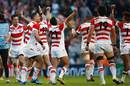 Japan players celebrate their surprise victory over South Africa