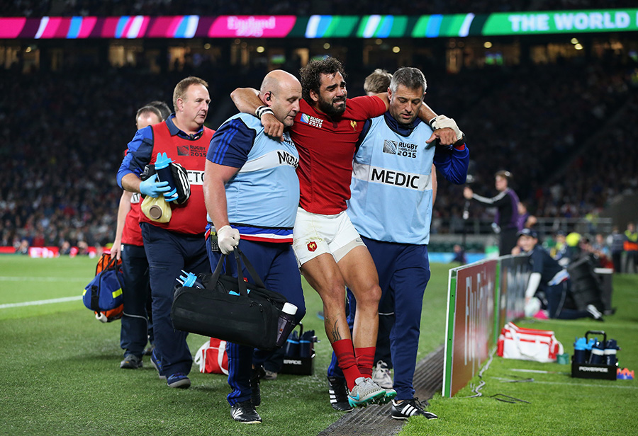 Yoann Huget of France is helped from the field following his injury