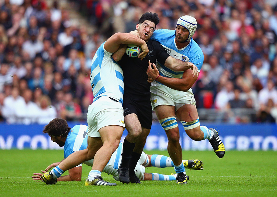Nehe Milner-Skudder of the New Zealand All Blacks tackled by Agustin Creevy, Juan Martin Fernandez Lobbe and Mariano Galarza of Argentina