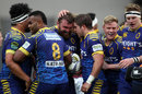 Liam Coltman of Otago celebrates his try with team-mates