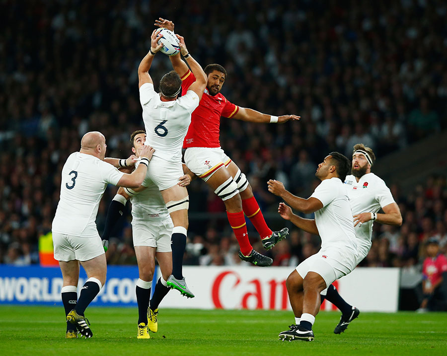 Tom Wood of England and Taulupe Faletau of Wales go up for the high ball 