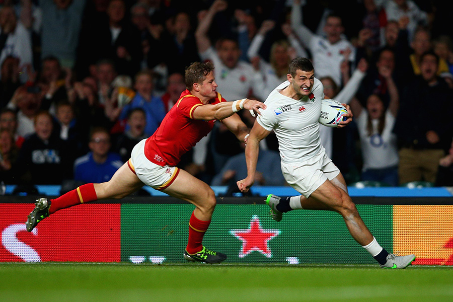 Jonny May of England beats Hallam Amos of Wales as he runs in to score their first try