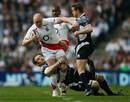 Chris Paterson and Jason White of Scotland look to stop England's Mike Tindall