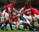 Stephen Jones of Wales looks to offload as he is brought down by Ireland's John Hayes