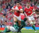 Wales' Lee Byrne tries to break through an Irish tackle before being forced off injured