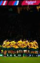 The Wallabies huddle as they celebrate victory