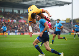 Valentin Calafeteanu of Romania leaps over Leonardo Sarto of Italy as he scores the opening try during the 2015 Rugby World Cup Pool D match between Italy and Romania at Sandy Park on October 11, 2015 in Exeter, United Kingdom. (Photo by Paul Gilham/Getty Images)