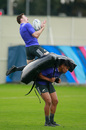 Colin Slade of the All Blacks leaps over Julian Savea during a New Zealand All Blacks training session