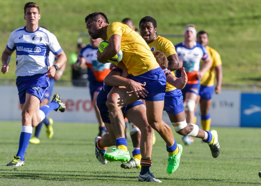 Karmichael Hunt of Brisbane City takes on the Greater Sydney Rams defence