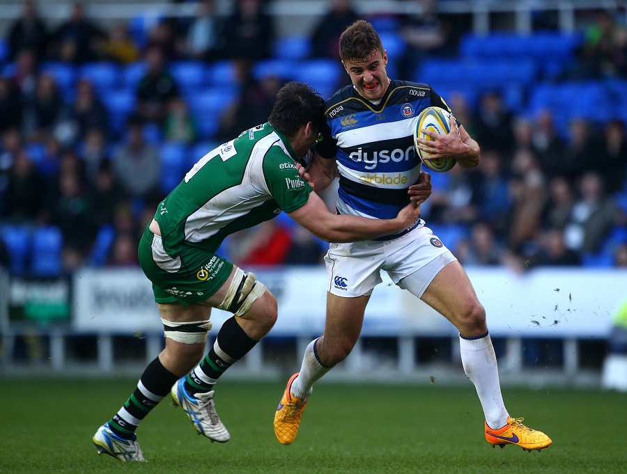 Bath's Ollie Devoto tries to hold off the tackle from London Irish's David Sisi 