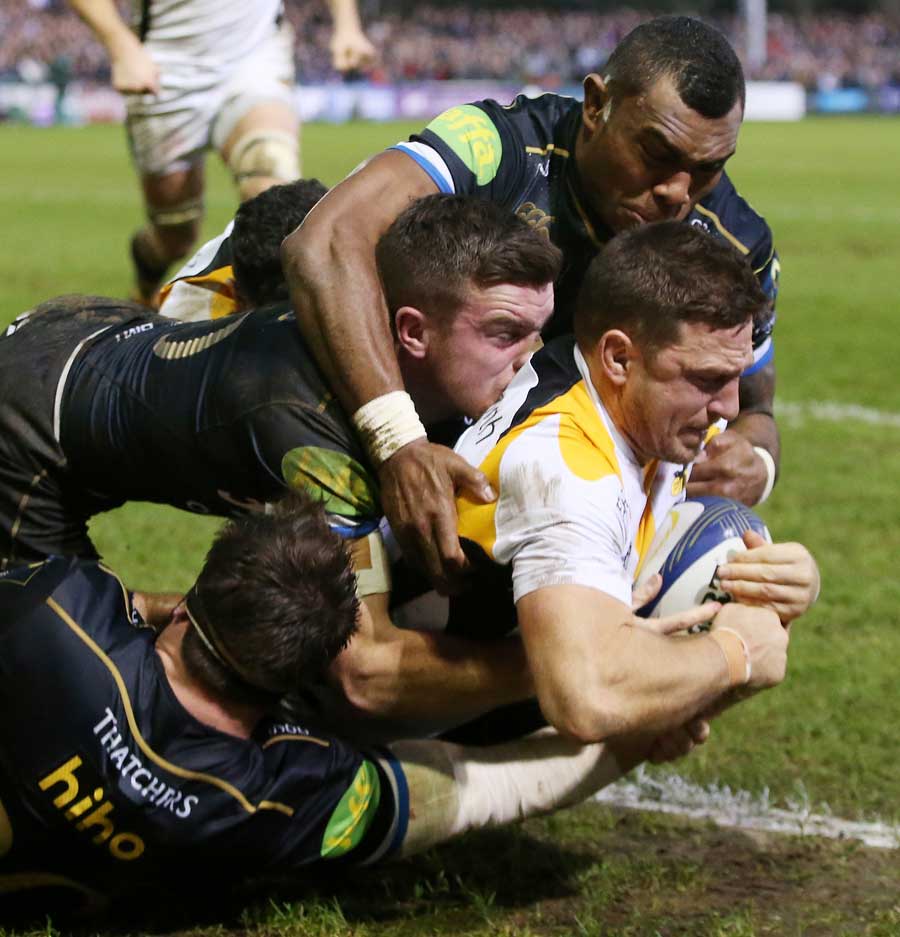 Jimmy Gopperth of Wasps holds off the Bath defence to score a try