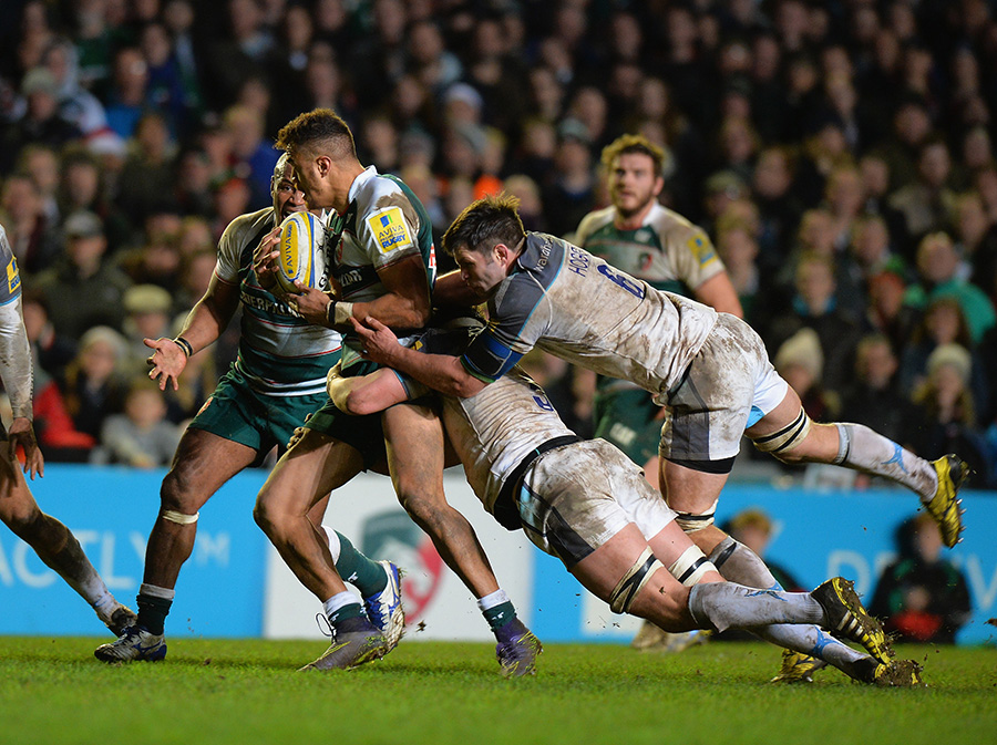 Peter Betham of Leicester Tigers is tackled by Sean Robinson and Ally Hogg of Newcastle Falcons