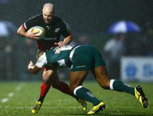 Charlie Hodgson of Saracens is tackled by Vereniki Goneva of Leicester Tigers during the Aviva Premiership match between Saracens and Leicester Tigers at Allianz Park on January 2, 2016 in Barnet, England.  