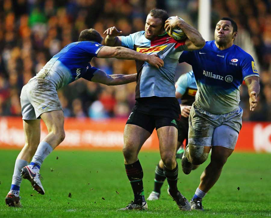 Jamie Roberts of Harlequins is tackled by Owen Farrell
