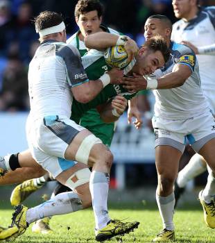 Alex Lewington of London Irish is tackled by Will Welch (L) and Marcus Watson (R) of Newcastle during the Aviva Premiership match between London Irish and Newcastle Falcons at the Madejski Stadium on January 10, 2016 in Reading, England. (Photo by Ben Hoskins/Getty Images)