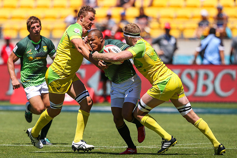 Siaosi Asofolau of Samoa is tackled by Tom Cusack and Stephan van der Walt of Australia during the 2016 Wellington Sevens cup quarter-final