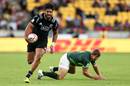 New Zealand's Akira Ioane beats the tackle of Kwagga Smith