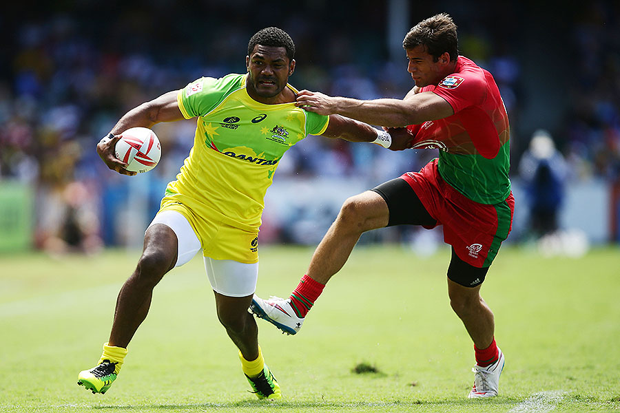 Australia's Henry Speight palms off a Portuguese defender at the Sydney 7s