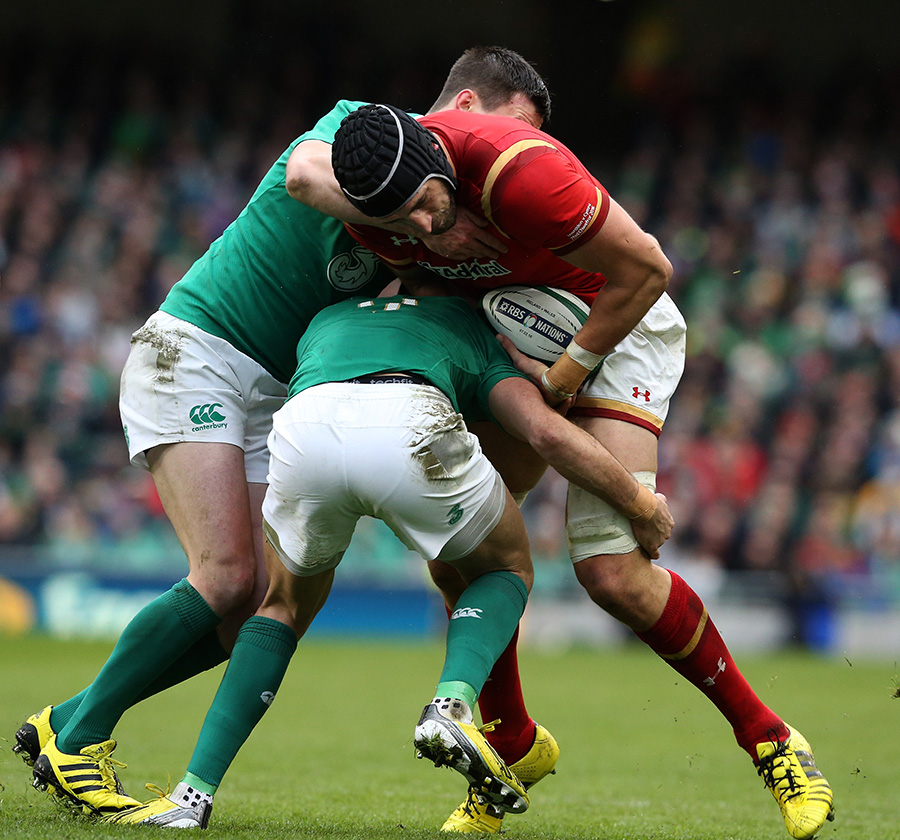 Luke Charteris of Wales is wrapped up by Jonathan Sexton and Conor Murray of Ireland